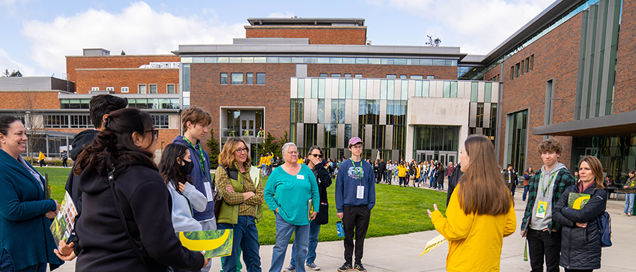 Large group gathering in front of the Erb Memorial Union EMU at Duck Preview