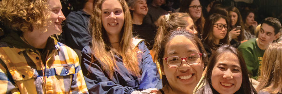 University of Oregon students gather for session and smile at camera