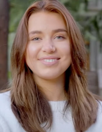 Jane smiles to camera on UO campus